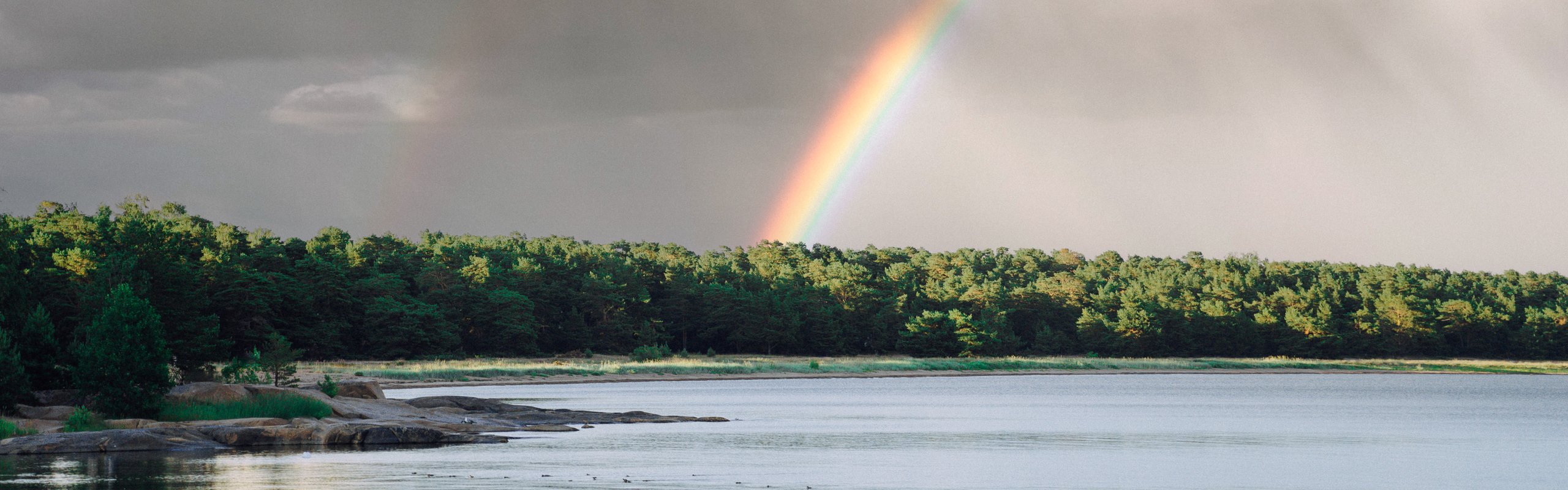 Sunset in the archipelago with a fabulous rainbow after the rain